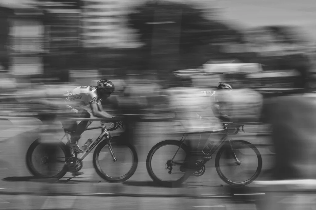 blurred picture of two men riding ebikes