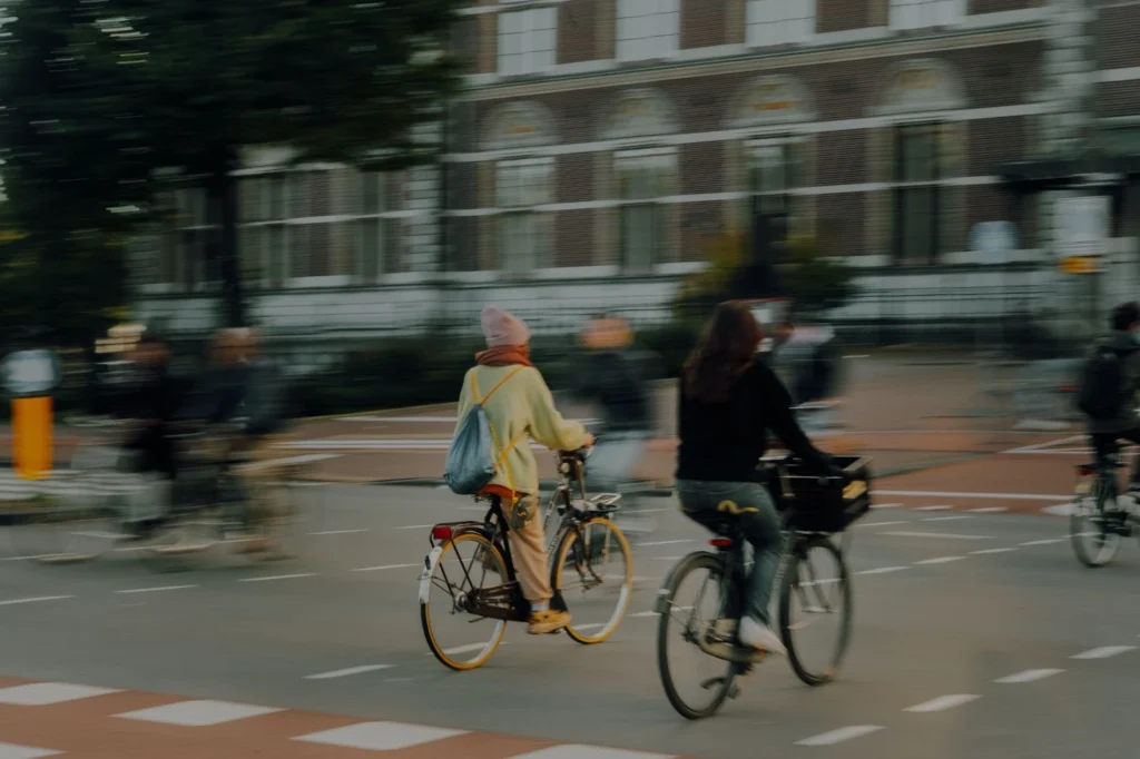 people riding bikes on the street blurred