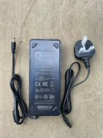 A ebike charger with a three prong socket in black
