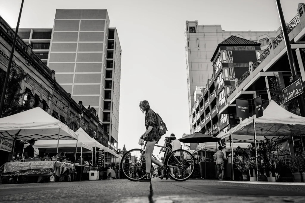 City scene of a girl walking a bike