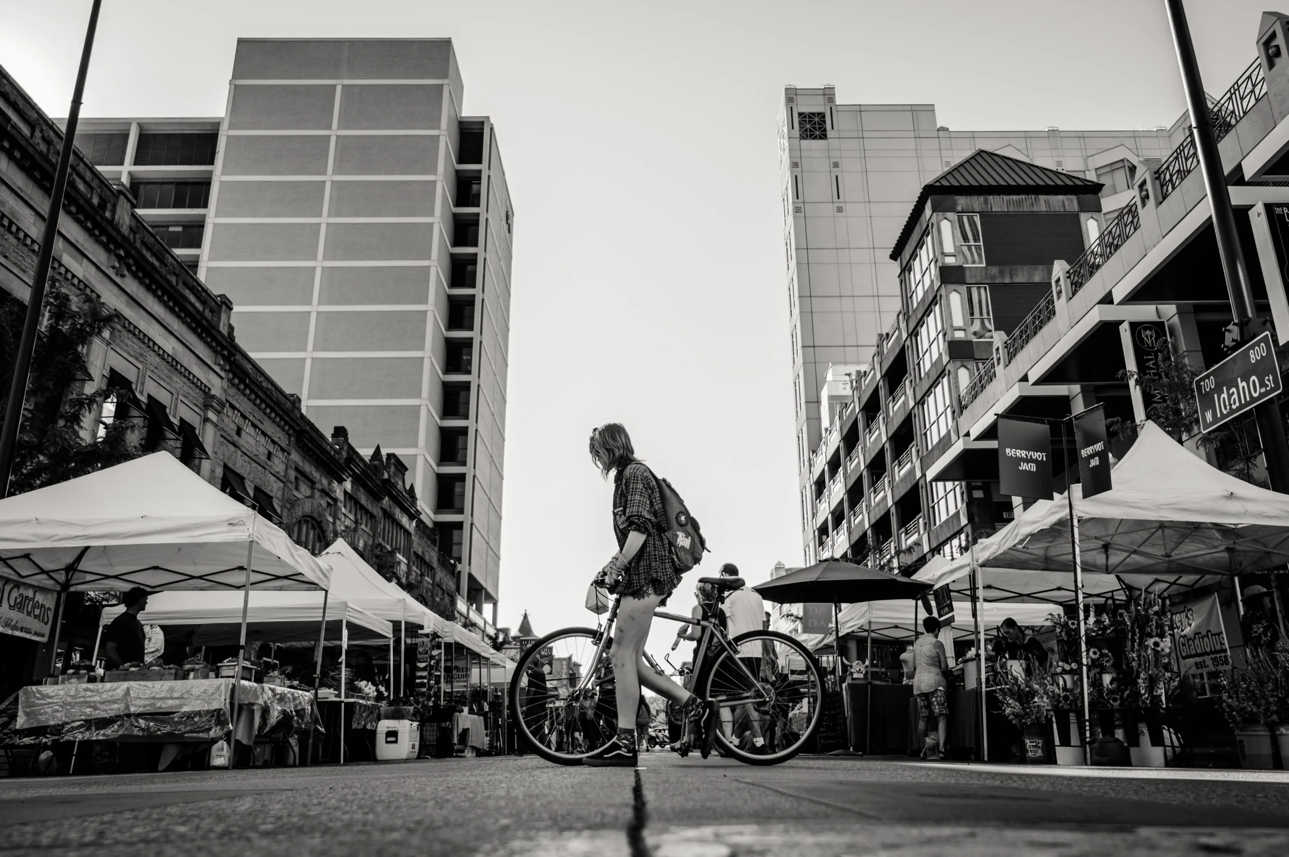 City scene of a girl walking a bike